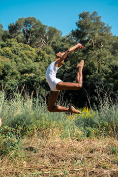 Portrait of expressive male dancer in nature jumping and moving