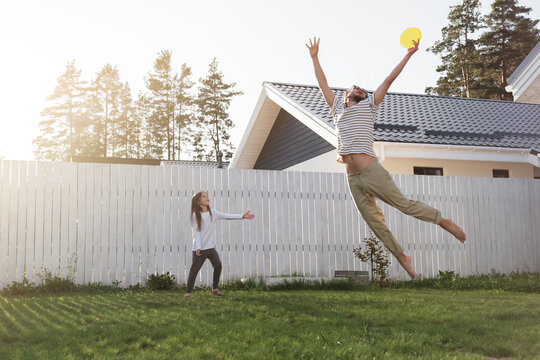 Father Catching Flying Disc Near Kid