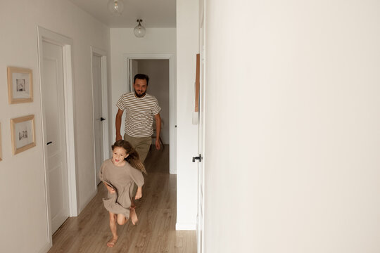 Father Chasing Daughter In Corridor