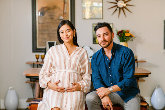 Expecting couple relaxing at home portrait