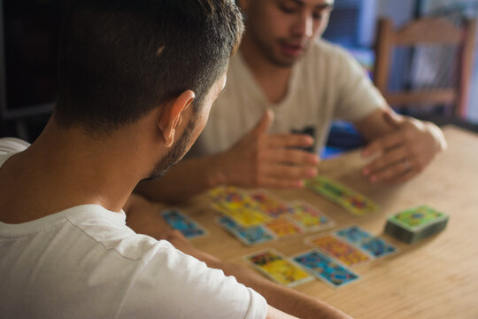 Two latino man reading tarot cards