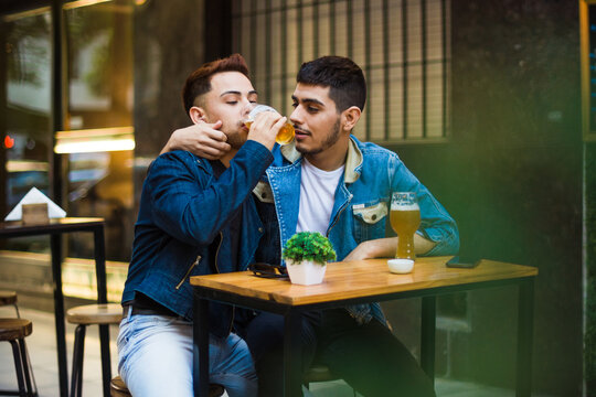 Gay latino couple at brewery