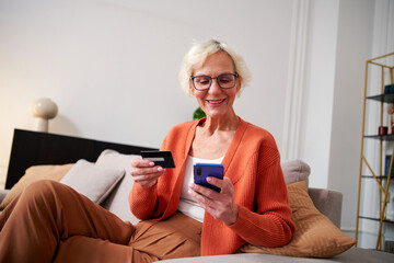 Elderly woman ordering goods online,
