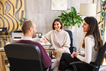 Positive psychologist smiling with happy couple