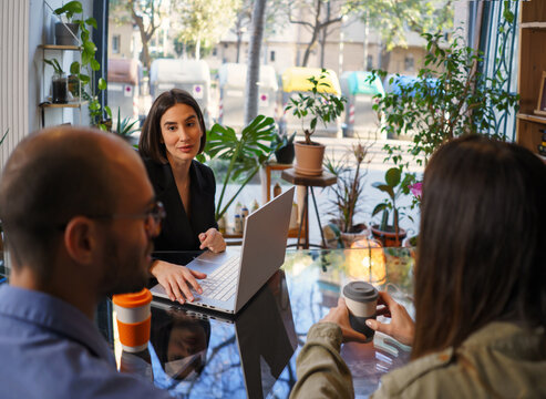 Smiling sexologist talking to couple during visit