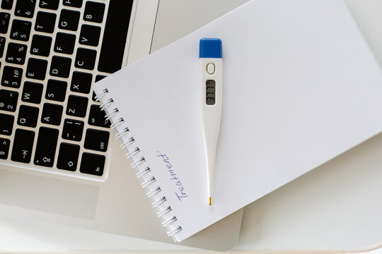 Electronic thermometer on notebook and laptop