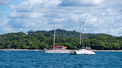 Sailboats moored in the bay, off the beach in Tamarindo, Guanacaste, Costa Rica