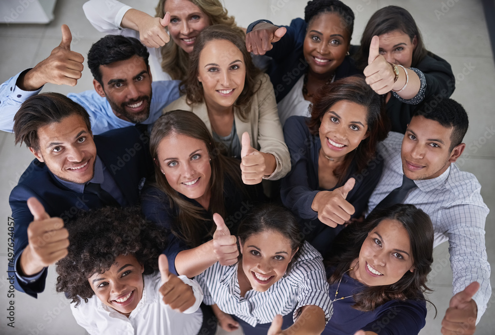 Poster this team is all about positive attitudes. high angle portrait of a group of coworkers showing a thu