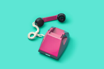 Retro style telephone over turquoise background