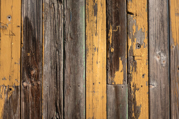 old colorful reclaimed wooden wall with various paint colors close-up