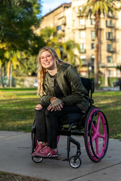 Woman in Wheelchair Smiles for a Portrait in a Park