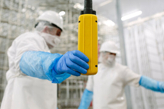 Workers in factory with push button switch