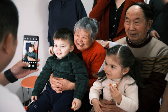 Chinese Uncle Takes A Phone Portrait Of His Extended Family In China.