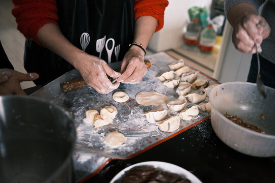 Chinese Women Make Dumplings At Home During Chinese New Year.