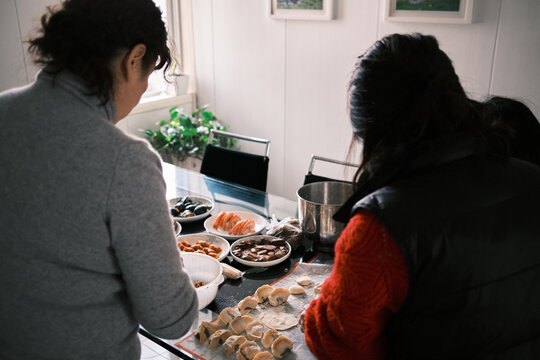 Chinese Women Make Dumplings At Home During Chinese New Year.