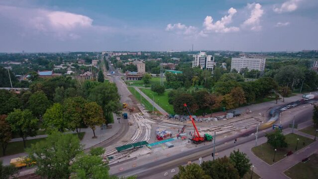 Road construction site with tram tracks repair and maintenance aerial timelapse.