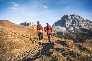 Two friends running into the mountains.