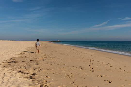 Kid walking by the beach