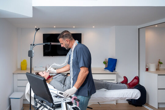 Male cosmetologist making skin care procedure to client