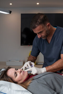 Woman receiving anti aging injection in salon