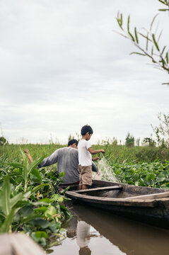 Father and son fishing in the amazon river