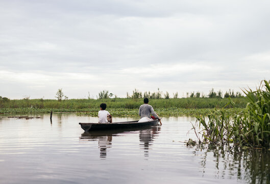 Father and son fishing in the amazon river