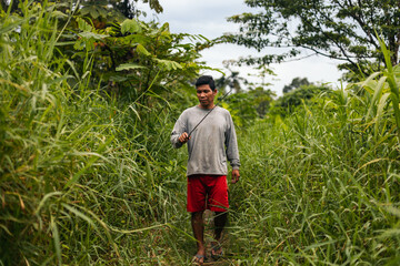Peruvian man walking through the jungle