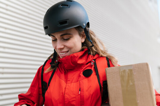 Content delivery woman with carton boxes on street
