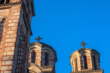 Close up of the towers of Church of Saint Mark, also called Crkva Svetog Marka with its typical orthodox christian cross and dome. It is an orthodox church and a major touristic landmark..... - obrazy, fototapety, plakaty