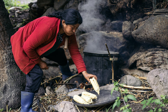 Latin woman cooking corn outdoor