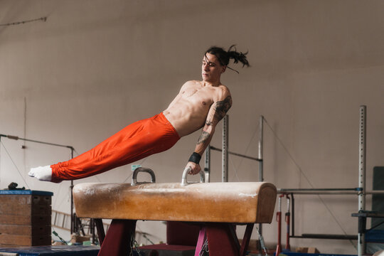 Male Gymnast Working Out His Routine On A Pommel Horse