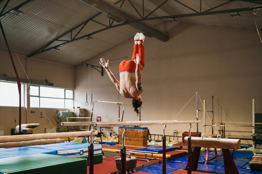 Anonymous Male Gymnast Doing Back Flip