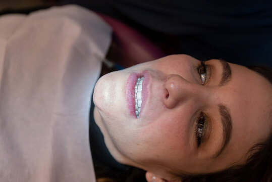 Female patient showing invisible orthodontics 