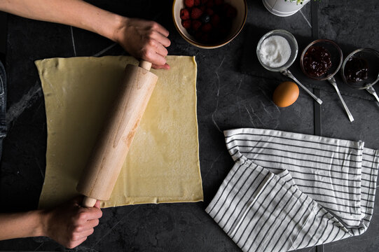 Crop woman rolling dough for pastry
