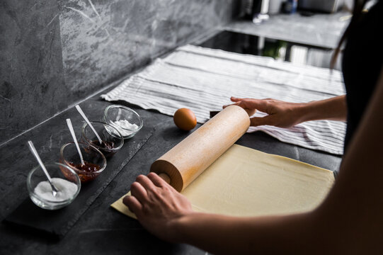 Crop woman rolling dough for pastry