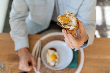 Top view of breakfast plate with eggs toast