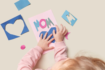 Child preparing greeting card for mother's day