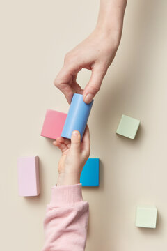 Mother and child playing with colorful wooden bricks
