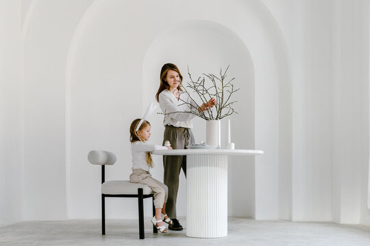 Woman and child decorating table for Easter at home