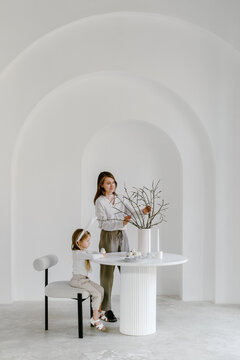 Mother and child preparing table for Easter celebration