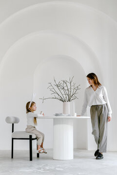 Mother and child at table decorated for Easter 