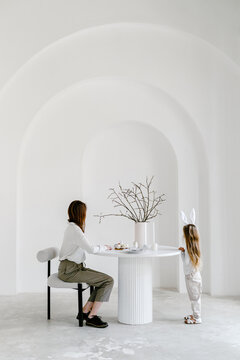 Mother and daughter at table with Easter decorations