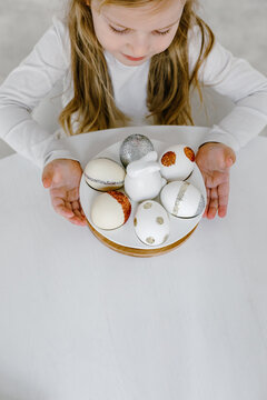 Child with decorated Easter eggs