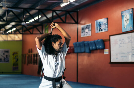 Man training martial arts with katana