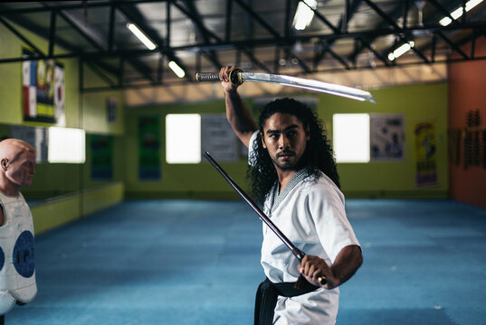 Man unsheathing the katana training martial arts