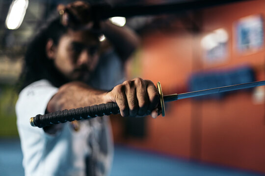 Close up man training with katana