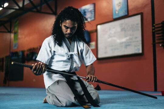 Martial arts fighter sheathing his katana
