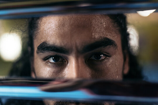 Intense gaze framed between a katana and a sheath