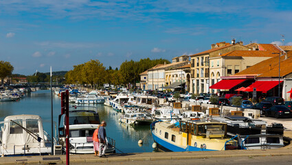 Fototapeta na wymiar View of bay with boats and old houses of Beaucaire, France