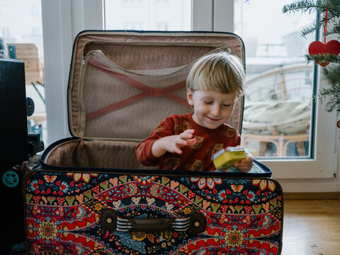 Boy playing in a suitcase